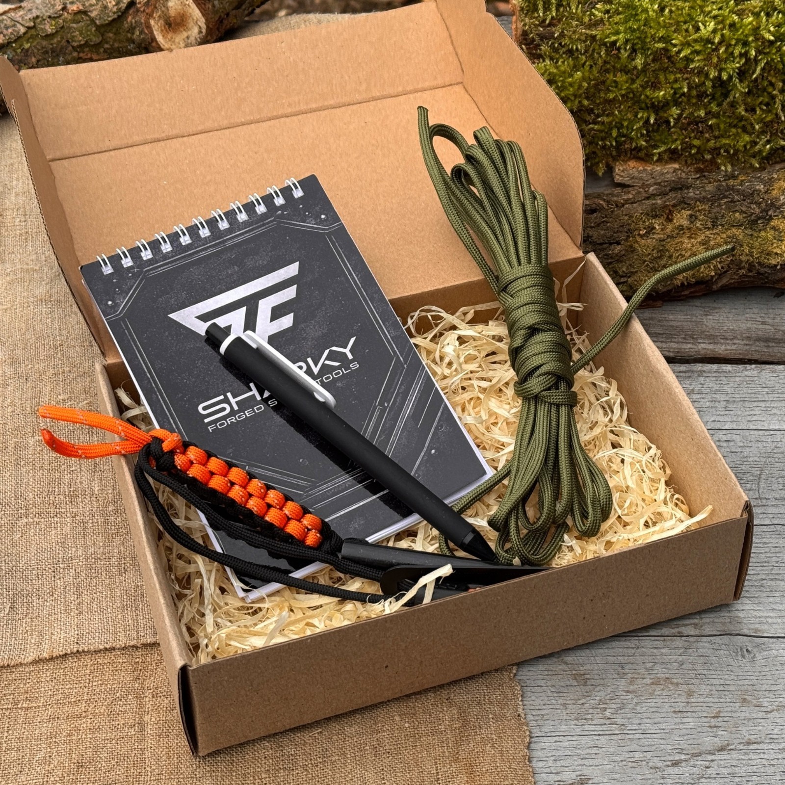 Camping Survival Kit with Ferro Rod Notebook Pen Paracord Bushcraft Gear Sharky