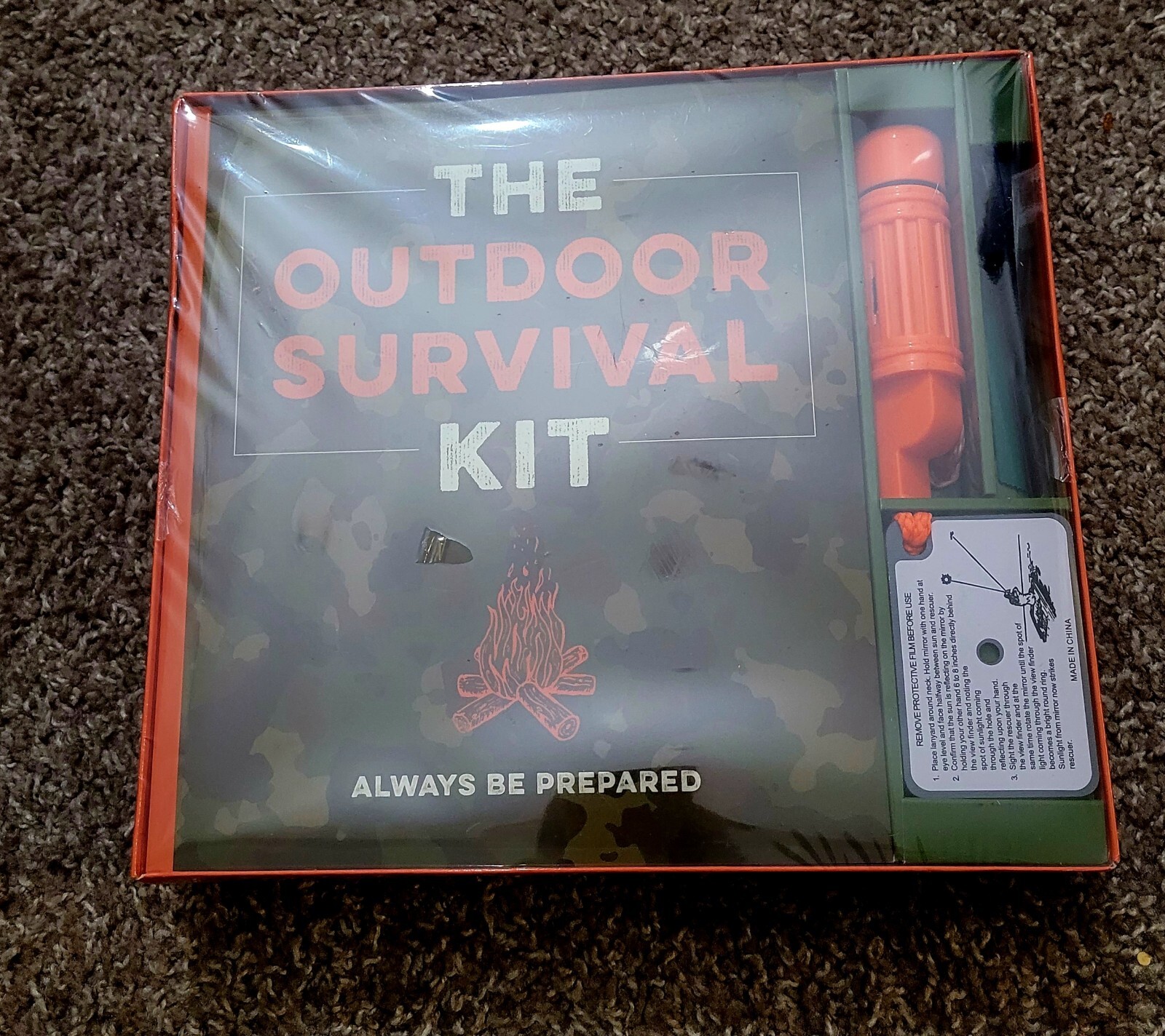 The Outdoor Survival Kit (Book, Firestarter, Mirror With Rope, Whistle, Compass.