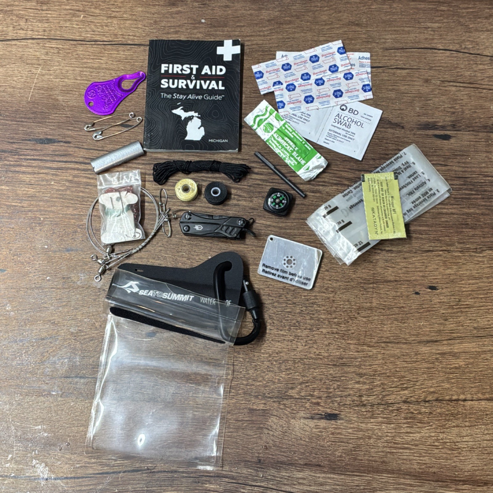 Waterproof Survival Kit with First Aid Guide, Compass, Multi-tool & Much More