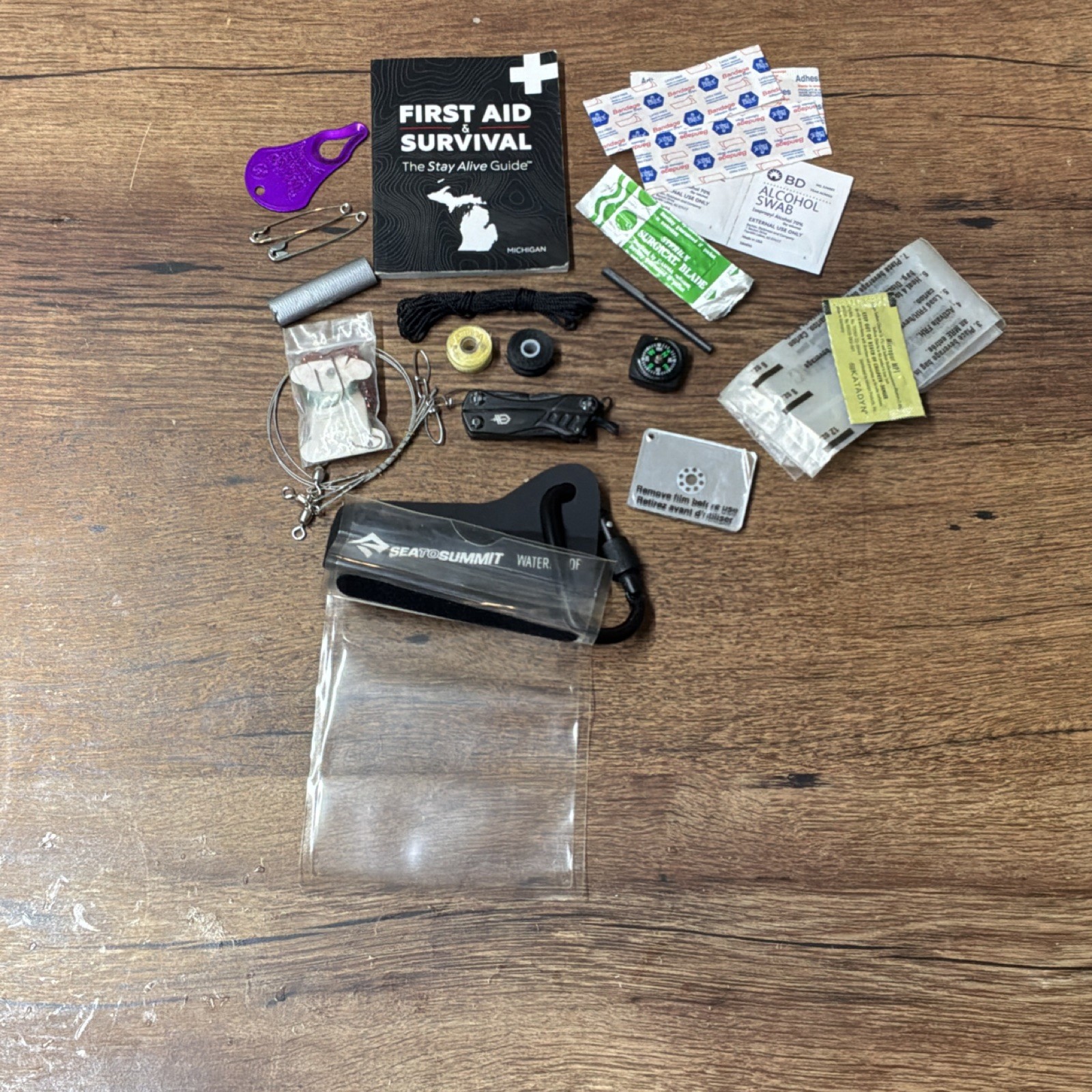Waterproof Survival Kit with First Aid Guide, Compass, Multi-tool & Much More