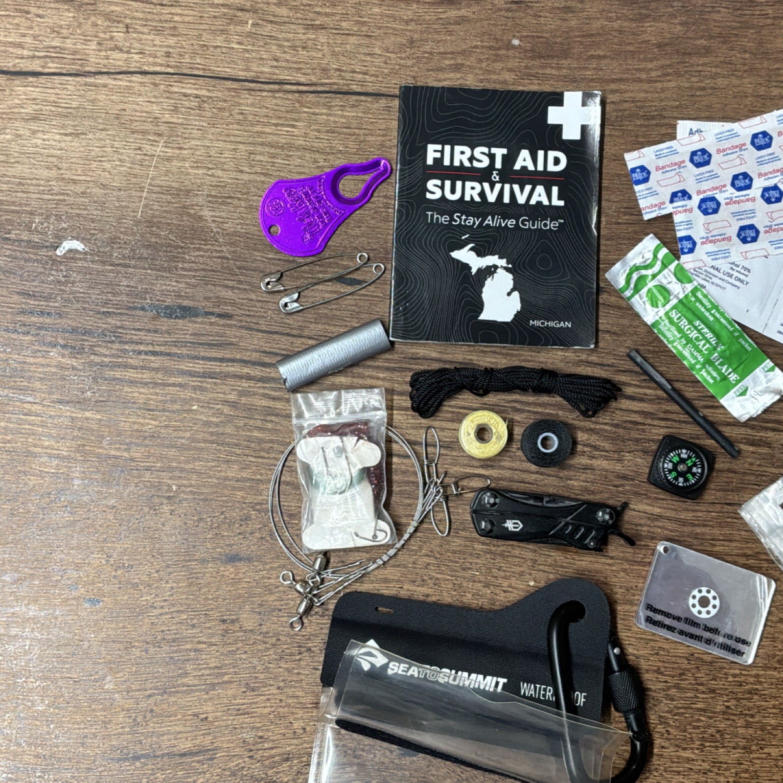 Waterproof Survival Kit with First Aid Guide, Compass, Multi-tool & Much More